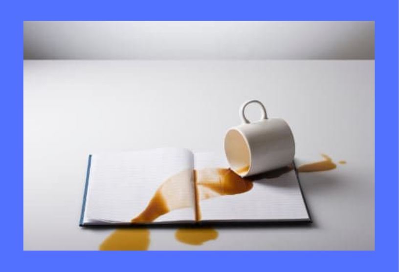 spilled-coffee-on-book-blue-background