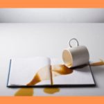 spilled-coffee-on-book-orange-background