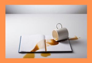spilled-coffee-on-book-orange-background