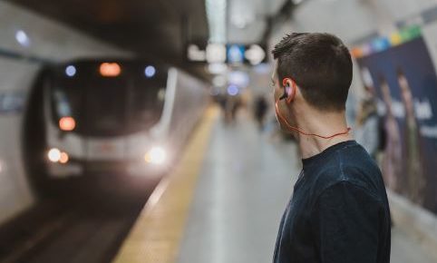 the-man-wearing-earphone-at-the-subway