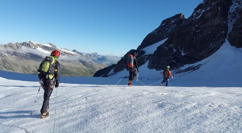 three-person-walking-on-the-mountain